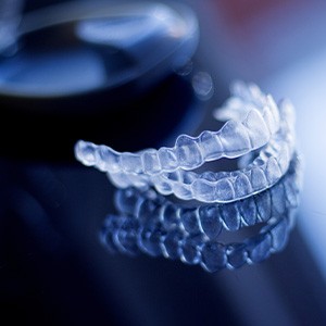Invisalign trays on dark reflective surface