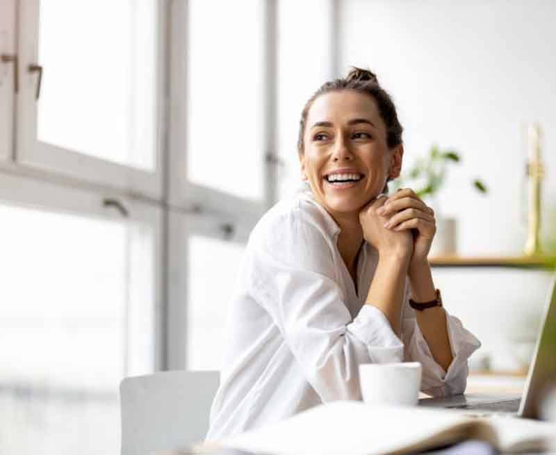 a woman smiling in a bright room