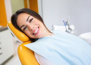 Woman smiling while sitting in treatment chair