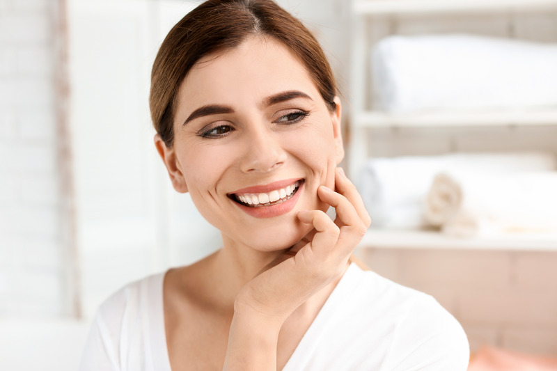 Patient smiling with their dental implants